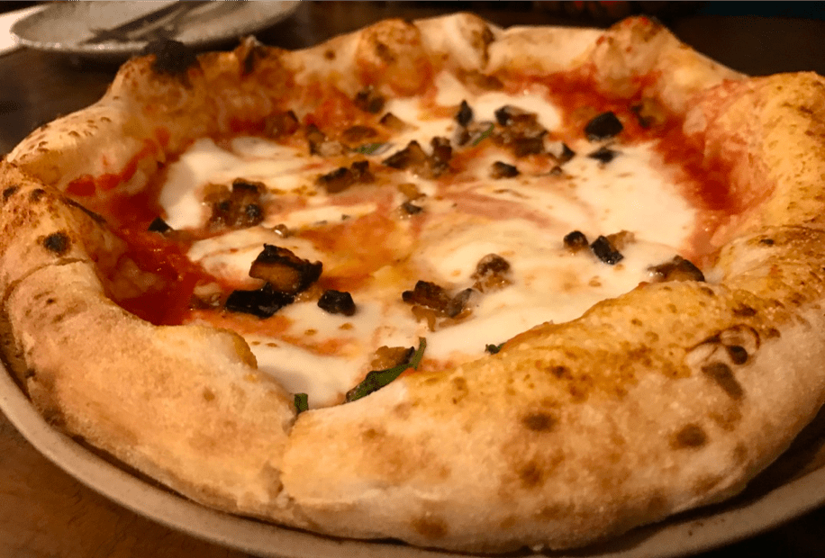 A pizza sitting on top of a table

Description automatically generated