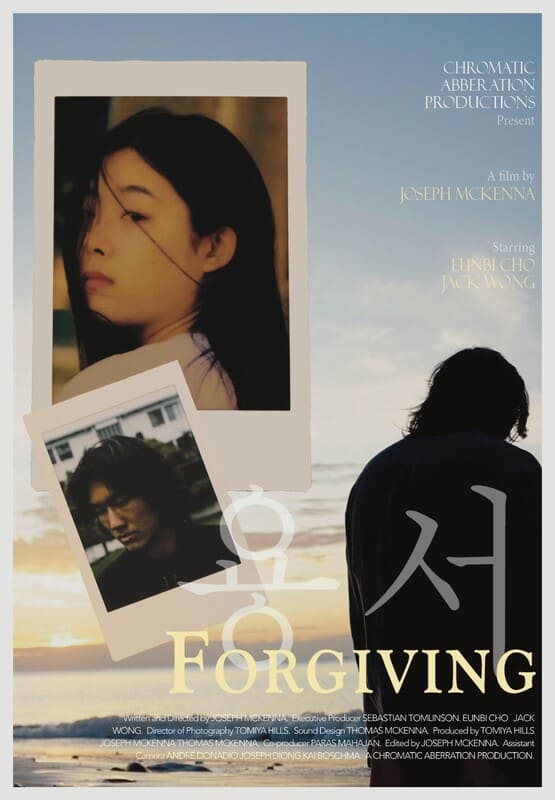A movie poster with two polaroid pictures on it, one of a woman and one of a man. The same man's back can be seen as he looks down surrounded by the